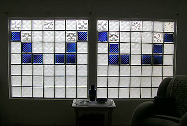 Sandblasted Decora pattern glass block windows with blue Delphi patter accents..